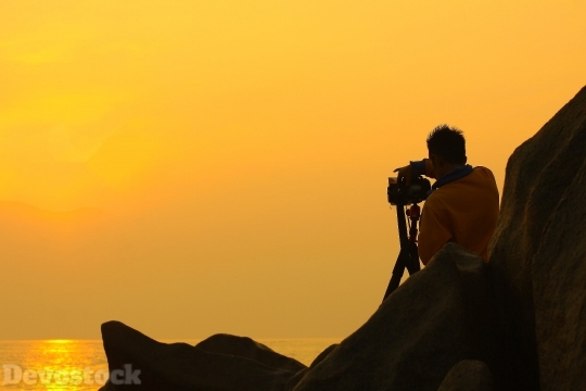 Devostock Man Taking Photos Sunset Sea 4k
