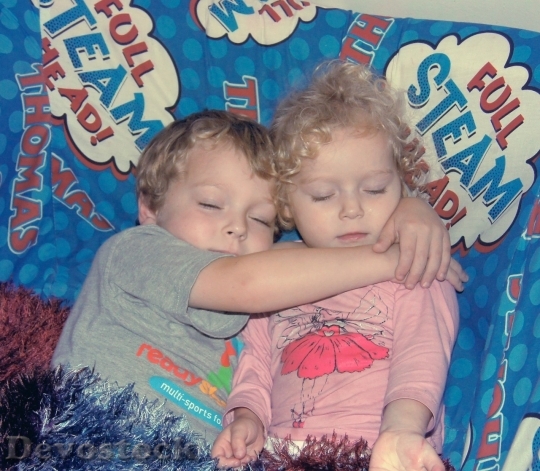 Devostock A boy and a girl sleeping and huging