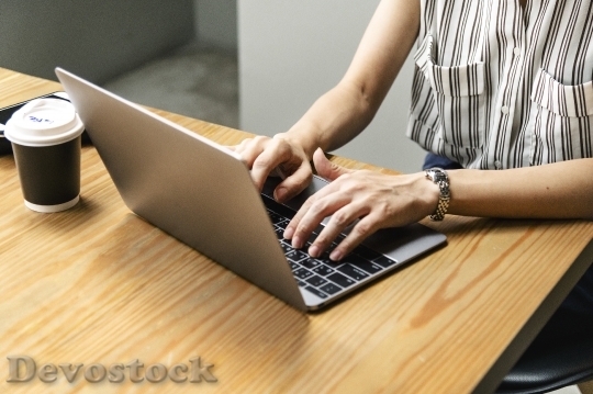 Devostock Japanese woman working on a laptop