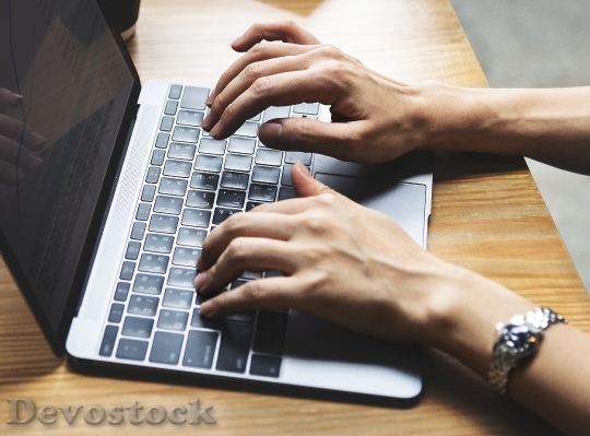 Devostock Woman typing on a laptop