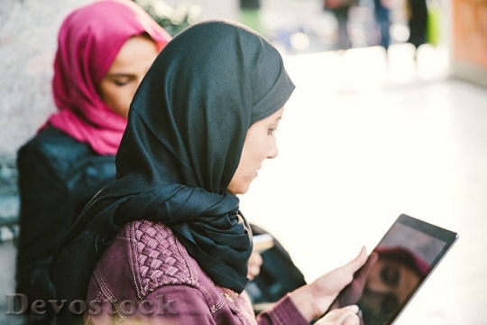 Devostock portrait-of-young-women-wearing-headscarf-reading-$1