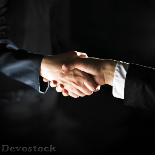 Devostock BUSINESSMEN SHAKING HANDS
