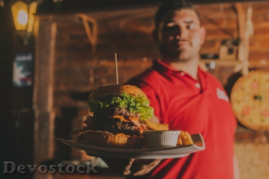 Devostock Man Giving Fast Food Lights 4K