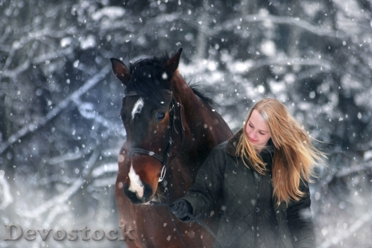 Devostock POLISH WOMAN WALKING PULLING HORSE SNOW