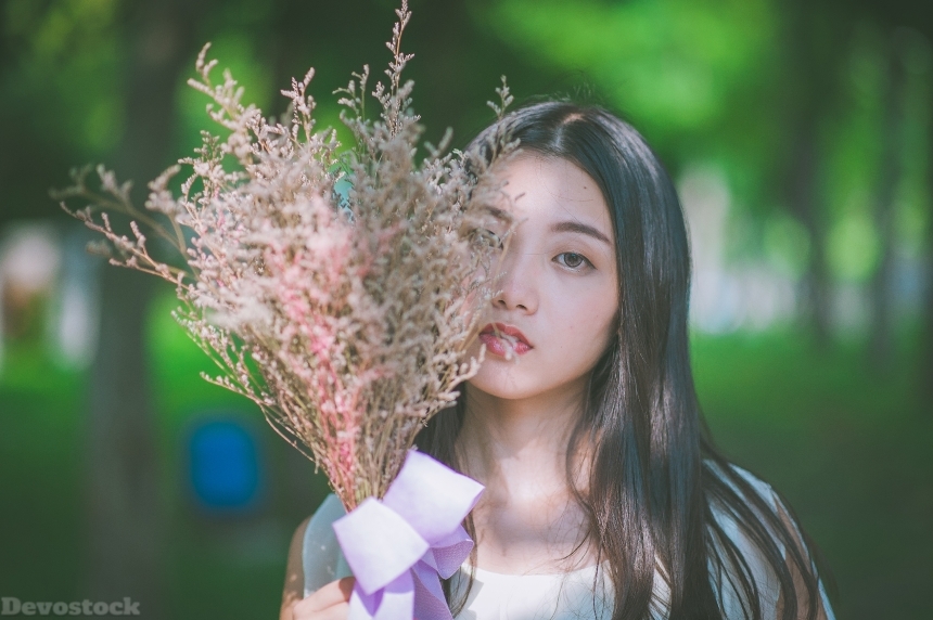 Devostock Asian Beautiful Girl Holding bunch Leaves Spring Love Passion Nature 4k