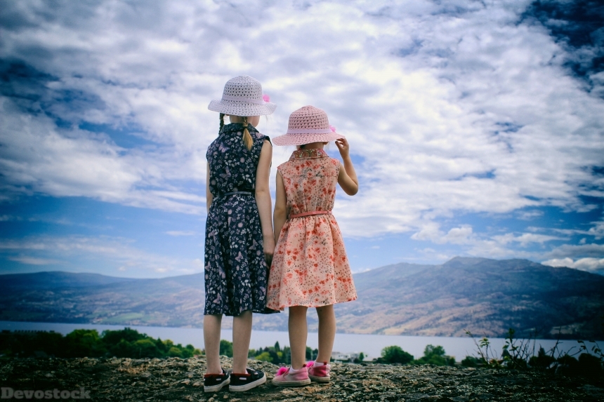 Devostock Back View Two Sisters Looking Outdoor Sky Love Family Concept 4k
