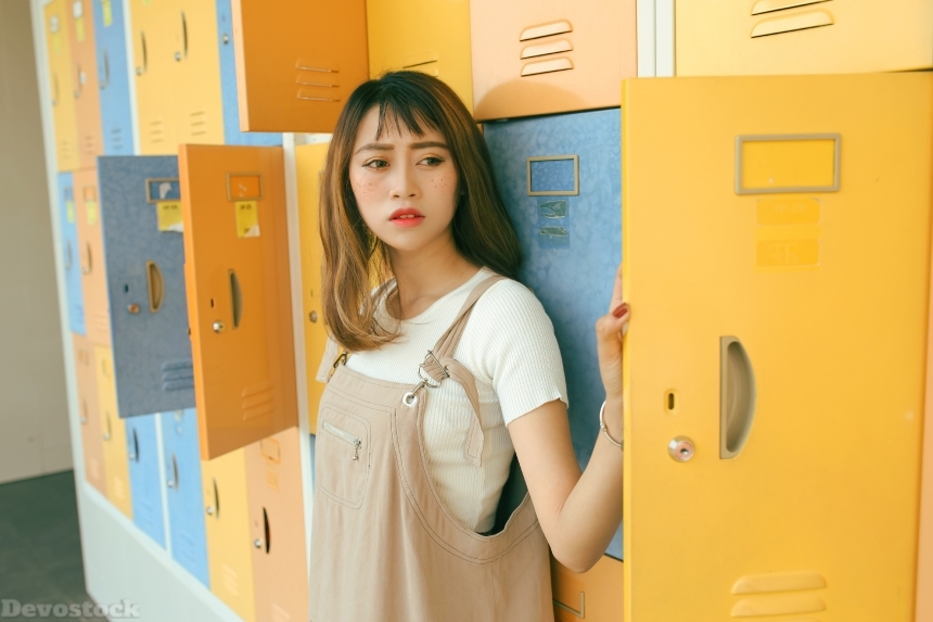 Devostock Beautiful Asian Girl Standing Lockers Thinking 4k