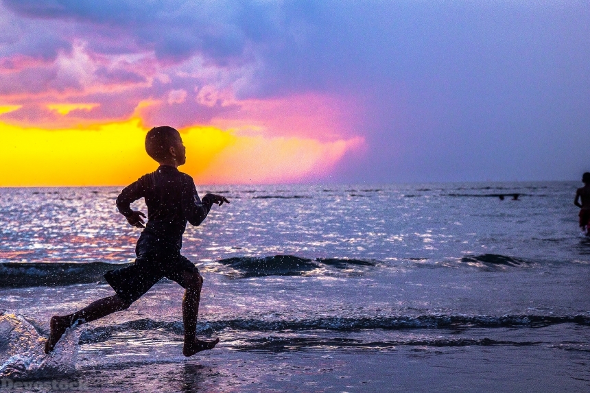 Devostock Boy Running Beach Sunset Water 4k