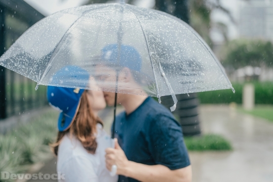 Devostock Couples Kissing Umbrella Raining Love 4k