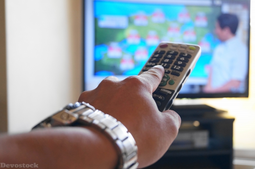 Devostock Man Hands Remote Control Changing Channel News Tv 4k
