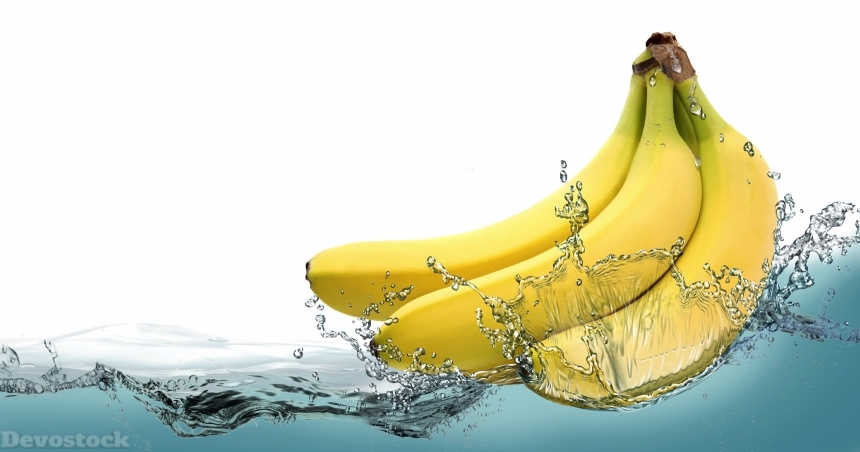 Devostock Ripe bananas on a background of splashing water.