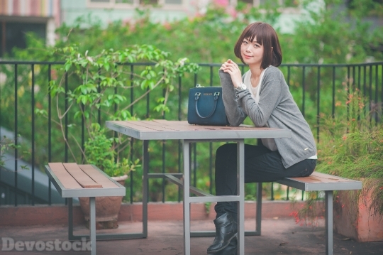 Devostock Taiwanese Lady Sitting Desk Daytime Girl 4k