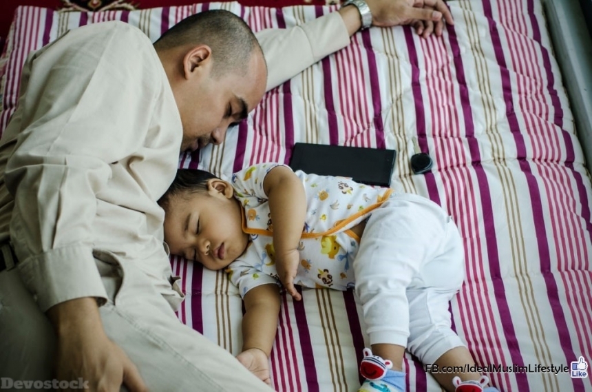 Devostock A  Muslim father sleeping with his son 