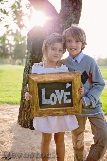 Devostock A boy and a girl holding love sign