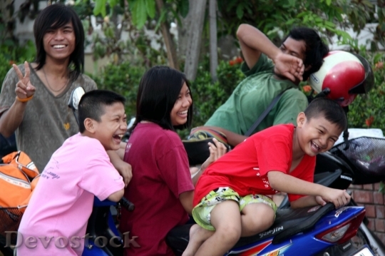 Devostock Asian family on the motor bike