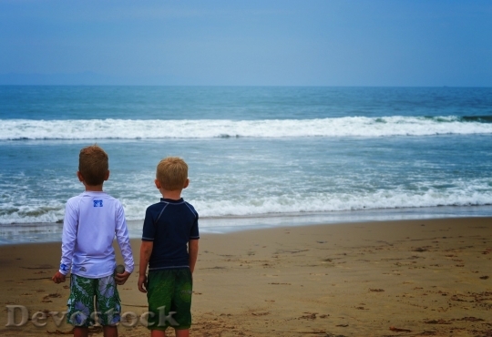 Devostock Boys looking at the beach