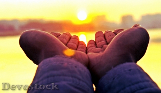 Devostock Sunset Hands Holding Sun