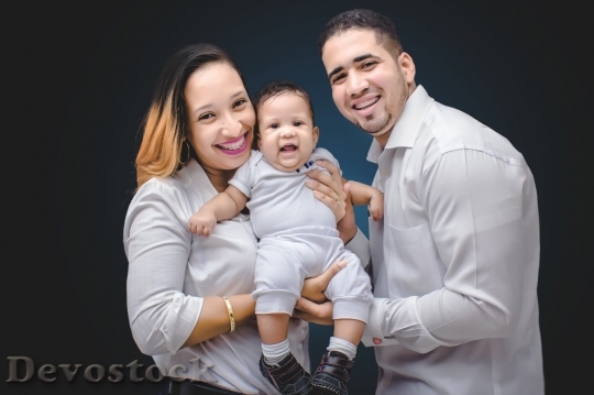 Devostock Family smiling with little baby boy
