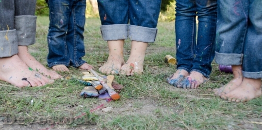 Devostock Family with dirty feet with paint