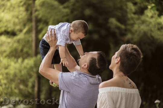 Devostock father holding his child up in the air