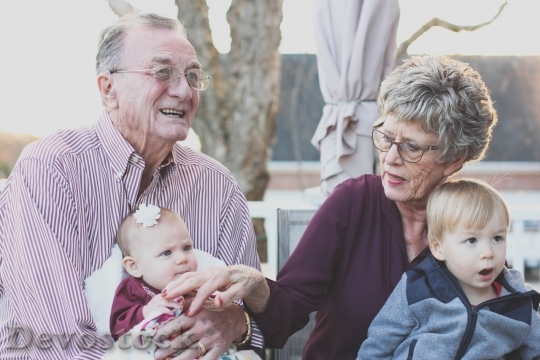 Devostock Grandparents holding their granchildren