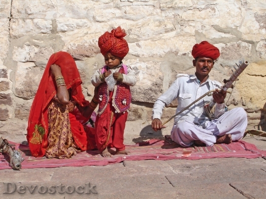 Devostock Indian family with father playing song