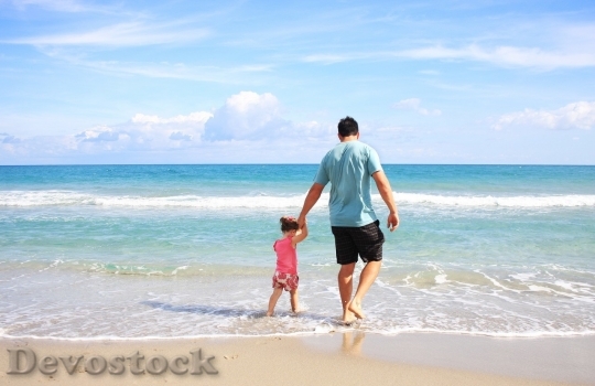Devostock Little girl and her father in the beach