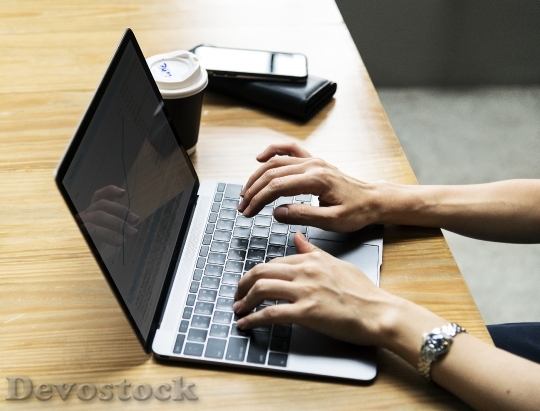 Devostock Woman using a laptop at work
