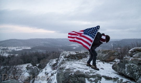 Devostock American Flag Holding Mountain