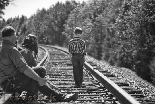 Devostock Boy Parents Walking Railroad