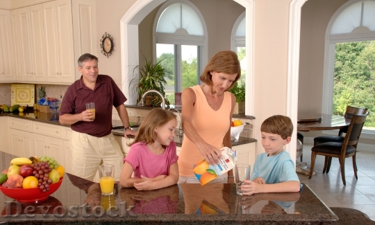Devostock Family Drinking Orange Juice