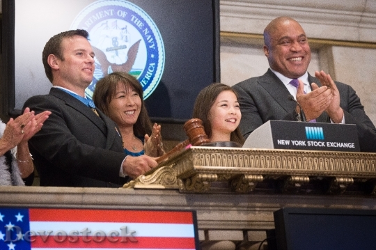 Devostock Medal of Honor recipient Senior Chief Special Warfare Operator (SEAL) Edward C. Byers, Jr., first from left, prepares to close the New York Stock Exchange.