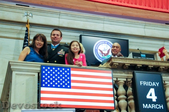 Devostock Medal of Honor recipient Senior Chief Special Warfare Operator (SEAL) Edward C. Byers, Jr., first from left, prepares to close the New York Stock Exchange.